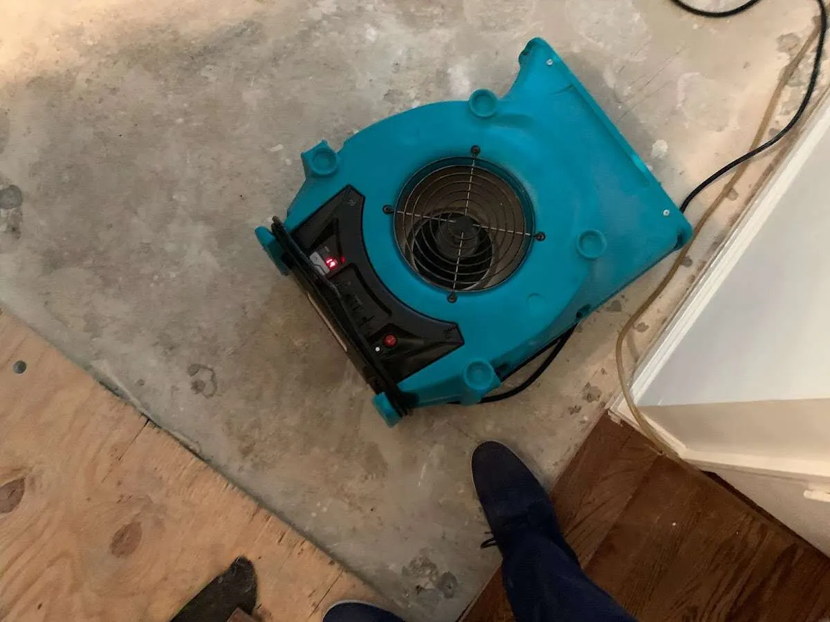 Air mover drying subfloor during Commercial Water Damage Restoration in North Palm Beach